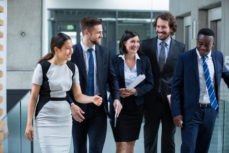 Businesswomen walking with colleagues in office